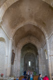 Saint-Trinit.<br> La nef comptait à l’origine deux travées, couvertes d’une voûte en berceau soigneusement appareillée, une troisième travée vers l’Ouest a été ensuite ajoutée. L’éclairage de la nef se fait par une étroite baie percée dans le mur Sud de la travée orientale. Le parement des murs de la nef compris sous les arcatures aveugles n'est pas appareillé ou l'est grossièrement.
