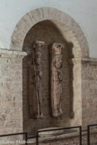 Saint-Philibert de Tournus. Le Musée Lapidaire.<br> CLes originaux des statues-colonnes du clocher. Les deux saints tournusiens et les deux cariatides sont du 12e siècle. Philibert est représenté avec le bâton abbatial à gauche et Valérien est sculpté avec la palme du martyre à droite.