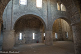 Saint-Philibert de Tournus. La Chapelle Saint-Michel<br> Les bas-côtés sont voûtés en demi-berceaux sur doubleaux en plein cintre, épaulant la voûte centrale. On y trouve des demi-colonnes aux murs latéraux et des baies-meurtrières éclairant l’édifice. Les espaces sous les deux clochers occidentaux ne sont pas voûtés et conservent des salles hautes s’ouvrant sur la nef par de belles baies géminées avec chapiteaux sculptés (à droite).