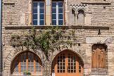 Cluny. <br> Lorsque la parcelle est plus large, les façades et les murs de refend possèdent deux arcades, comme c'est le cas au n°12. Cette maison, modernisée à la fin du XVIIIe siècle, a perdu une partie de sa claire-voie à six baies. Les fenêtres étant très représentatives du rang et de la position sociale de l'habitant, il est compréhensible, bien que l'on regrette la modification, que de telles opérations aient été pratiquées. 12 Rue d’Avril : Maison Descours, façade à deux arcades et baie géminée à colonnette, chapiteau et arcatures, 12e siècle, murées.