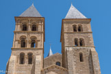 Le clocher sud est encore de la fin du 11e siècle et possède deux étages supérieurs aux baies géminées de petite ampleur avec doubles colonnettes et chapiteaux frustes. Les trois étages supérieurs du clocher nord sont du début du 12e siècle et ses doubles baies sont richement décorées dans le style du Brionnais : colonnettes torsadées, demi-colonnes, corniches, arcatures, tailloirs à billettes et des chapiteaux fantastiques. L’étage supérieur du narthex, ou chapelle Saint-Michel, est accessible depuis la nef par un escalier étroit. Elle servait aux offices pour les morts des moines clunisiens.