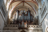 La tribune supportant le buffet d’orgue est du 18e siècle. L'orgue de tribune date de la fin du XVIIe siècle. Le buffet est classé au titre des monuments historiques en 1846, alors que la partie instrumentale est inscrite à titre objet en 1972. Le grand orgue initial subsista jusqu'en 1751. À cette date, on fit appel à Karl-Joseph Riepp (1710-1775), facteur d'orgues, qui construisit l'instrument actuel, initialement à quatre claviers et quarante-quatre jeux (réduit à trois claviers vers 1850).