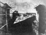 En 1816 il obtint la première photographie: une vue de sa mansarde où était installé son atelier. Mais l'image obtenue était un négatif. Il chercha alors des substances qui blanchissent à la lumière afin d'obtenir directement une image positive. Il exposa une plaque métallique (étain ou cuivre) recouverte d'un vernis composé de bitume de Judée dissous dans de l'essence de lavande. Les parties exposées à la lumière durcissaient. Il lavait la plaque ce qui éliminait le vernis des parties sombres et mettait à nu la plaque métallique qu'il attaquait ensuite avec un acide, les parties correspondant aux régions claires étant protégées par le bitume durci. Il pouvait alors, par simple ancrage, tirer des épreuves positives. Il appela ce procédé héliographie. En 1826, ap^rès plusieurs heures de pose, il obtint la première photo d'extérieur (Plaine de la Saône, vue de sa mansarde). C'est cette même année qu'il est sollicité par un peintre décorateur, Daguerre.
