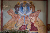 Saint Irénée. <br> Les fresques relatant la vie du Christ : la Transfiguration est le changement d'apparence corporelle de Jésus pendant quelques instants de sa vie terrestre, pour révéler sa nature divine à trois disciples, Pierre, Jean et Jacques, qui sont projetés à terre. Aux côtés de Jésus se tiennent deux grandes figures bibliques : Élie et Moïse. Les montagnes sont représentées par des sortes de pavés.