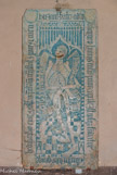<center></center><center>L'église paroissiale Saint-Laurent </center>Au bas des marches, à droite, se dresse contre le mur la dalle funéraire d'Oddon de Luyrieux qui se trouvait dans une chapelle du prieuré. Les os du squelette sont agencés de façon fantaisiste. Dans la bordure coupée aux quatre angles par des écussons des Luyrieux qui semblent avoir été martelés,  se trouve l'inscription funéraire. 15e siècle