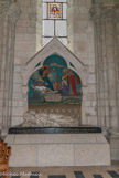 <center>Basilique St Nicolas. </center>  Le cénotaphe en mémoire de monseigneur Fournier qui fut initiateur de la construction de l'église et évêque de Nantes. Il fut endommagé lors du bombardement de 1943. En haut, le vitrail le représentant.
