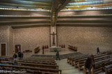 Le Sanctuaire de Notre-Dame de Vie de Venasque. <br> Chapelle Sainte Emérentienne. Le mur principal en pierres de Crillon apparentes s’ouvre sur le chœur tels deux larges bras et s’impose comme une image significative de l’Eglise corps mystique du Christ : chaque pierre est différente, chacune a sa place plus ou moins importante, mais toutes sont nécessaires. Hauteur maximale sous la voûte : 17 mètres. Largeur : 42 mètres.
Profondeur : 36 mètres.
Surface : 970 m2. Surface du chœur : 110 m2.
Longueur du portique central, entre les piliers : 28 mètres.
Largeur des poutres du portique : 2 mètres Largeur des coques : 2,50 mètres.
La plus longue coque : 26,60 mètres ; 22,75 tonnes.
Nombre de places assises : 785